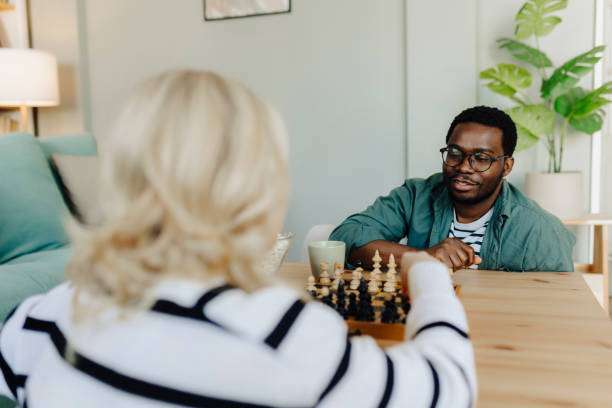 Couple playing chess on a chessboard table
