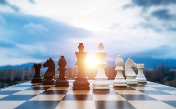 Black and white chess pieces on chess board.