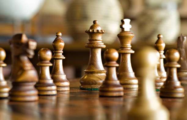 Close-up of classic wooden chess board pieces.
