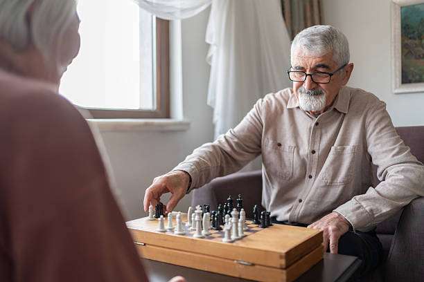 Businesswoman with hands clasped making decisions with a calm and collected demeanor in front of chess board.