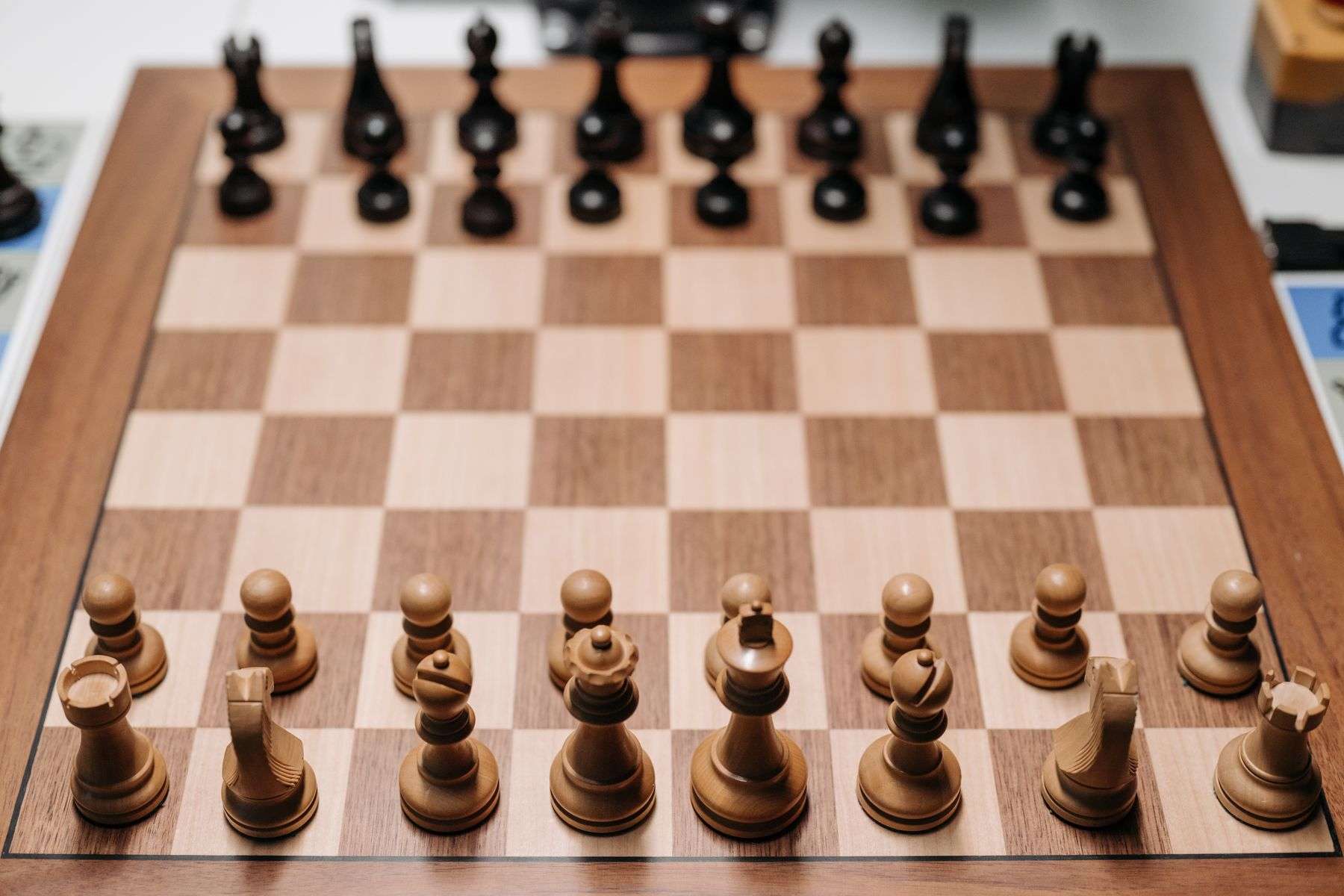 Wooden chess board arranged with a complete set of pieces