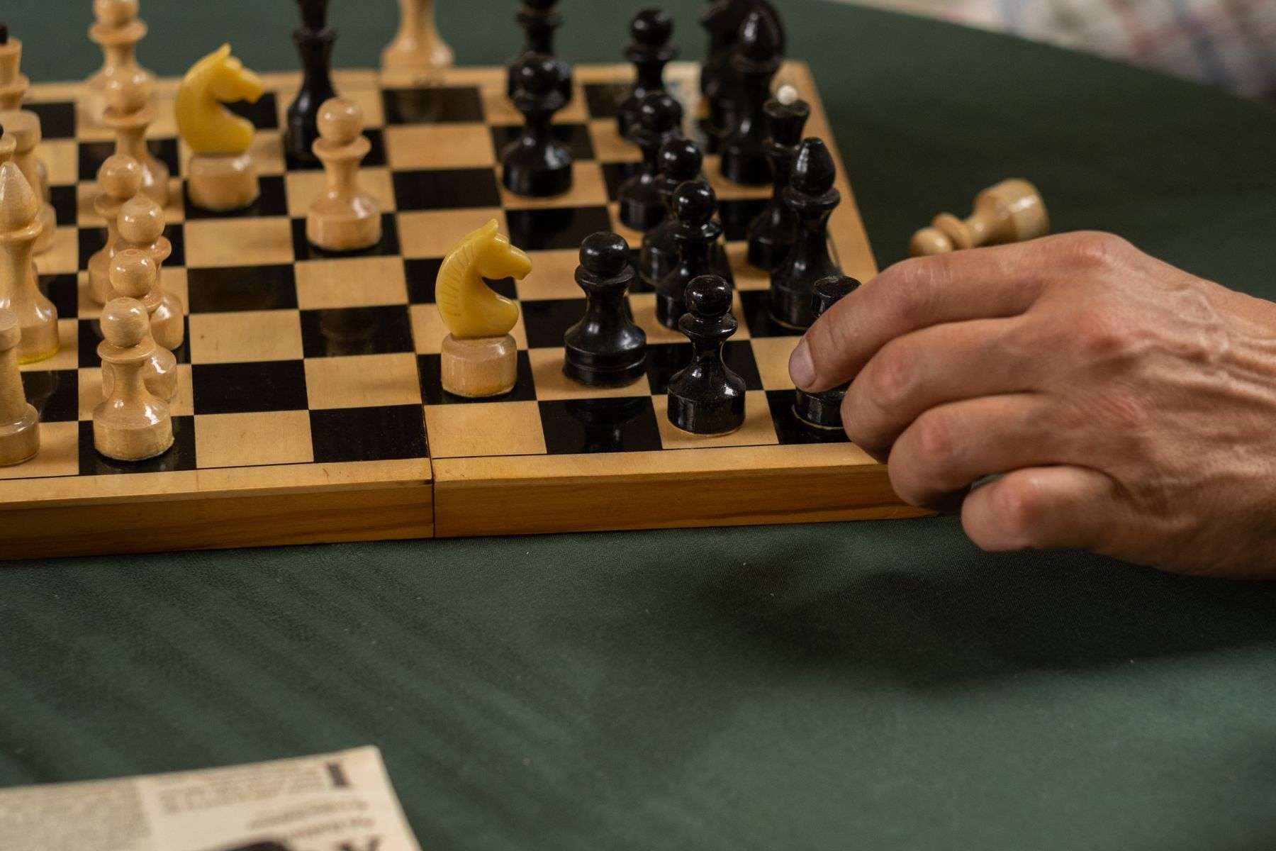 Chess set in active play on a wooden board