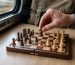 Compact magnetic travel chess set played on a train table