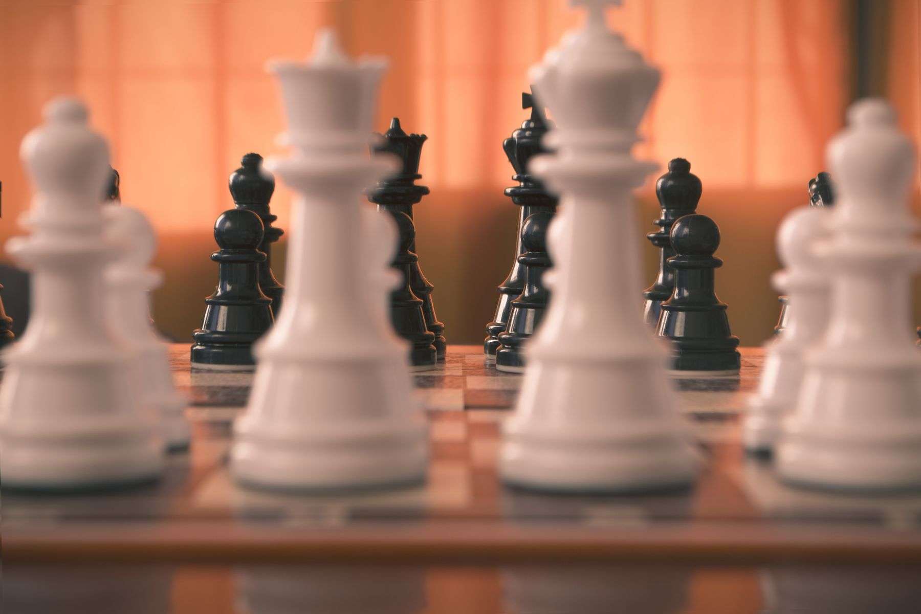 Warm close-up of a wooden chess set during play